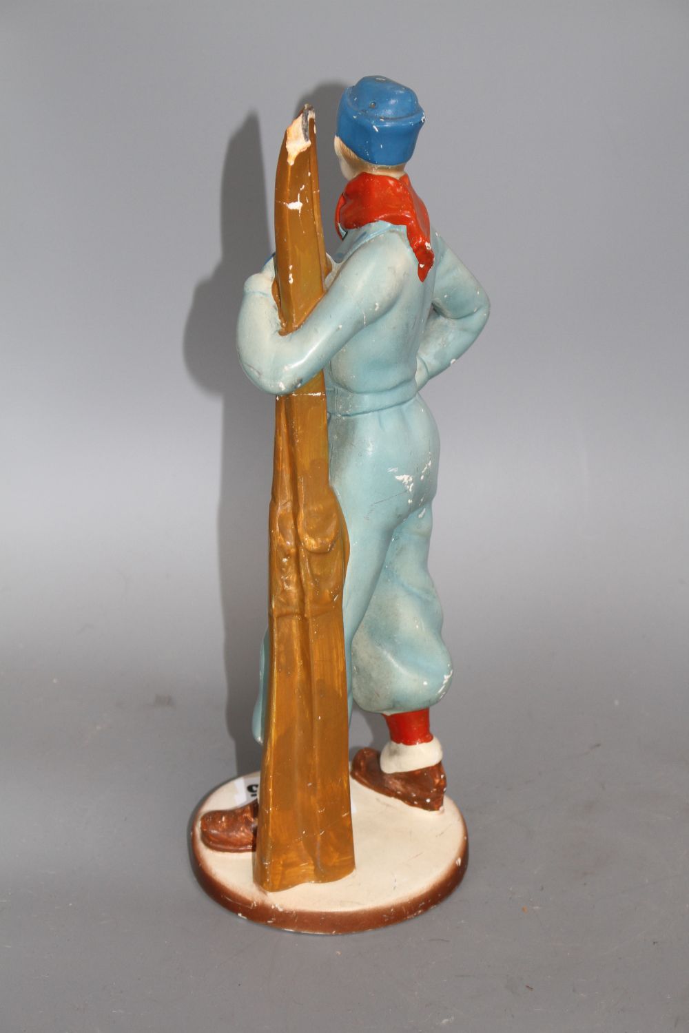 A 1930s painted plaster model of a skier, height 33cm